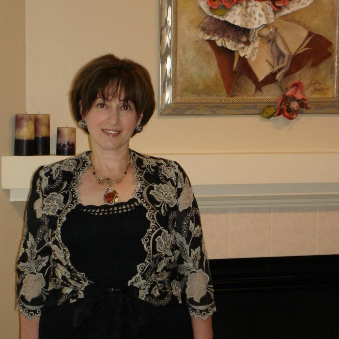 Marina Davar, healthcare educator and practice manager in Cincinnati, Ohio, wearing a black dress and a floral lace jacket
